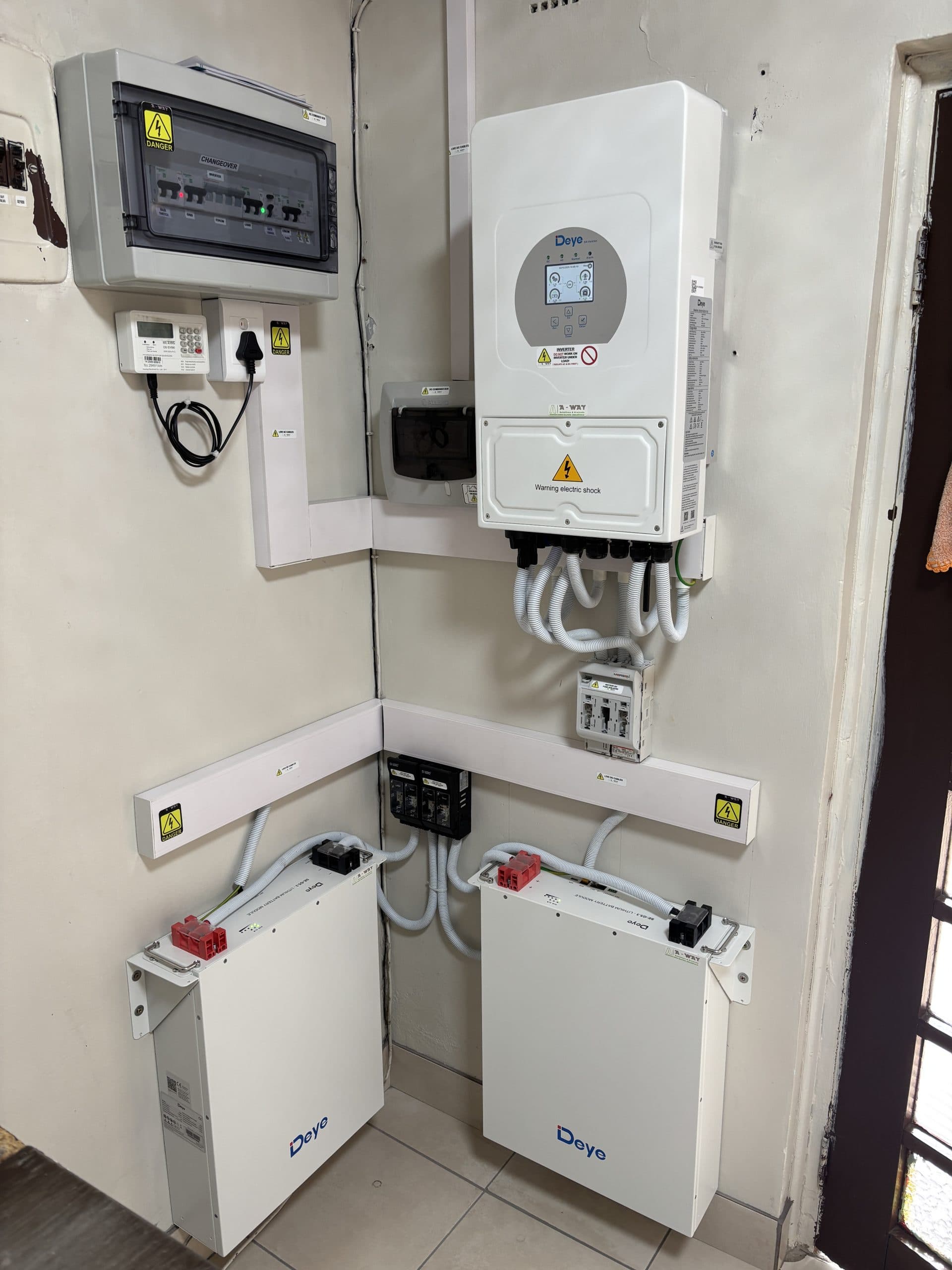 Battery storage modules installed beside an inverter.